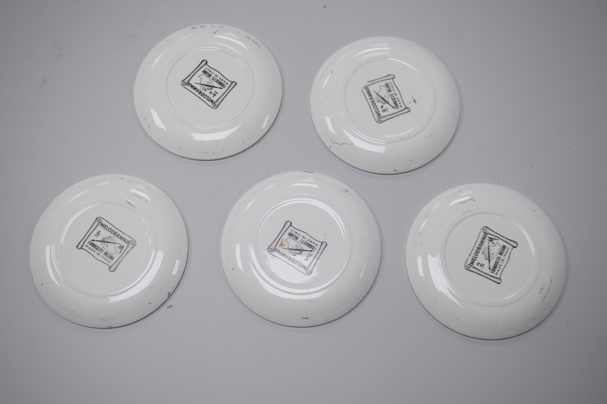 Fornasetti, a group of five operatic coasters, ‘Melodramma’ to include Otello and Desdemona, 10cm in diameter